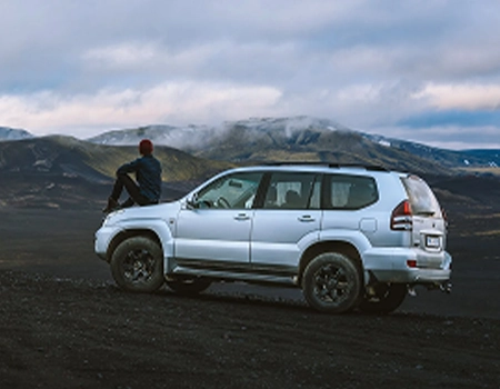 Silver SUV parked in a mountainous landscape